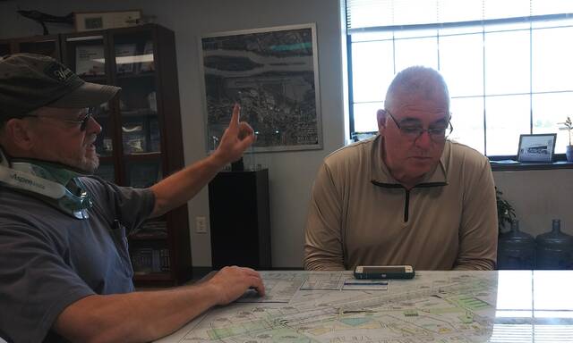 <p>James Scrobola, a representative of Valley Aviation, which runs Luzerne County’s Wyoming Valley Airport in Forty Fort and Wyoming, details proposed projects as county Councilman Brian Thornton reviews a map of the complex layout.</p>
<p>Jennifer Learn-Andes|Times Leader</p>