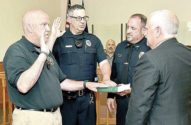 <p>Stephen Bekanich, left, and Leonard Insalaco, left center, are sworn in as Sergeants of the Wyoming Area Regional Police (WARP) department by Luzerne County President Judge Michael Vough, right, with new WARPD chief Michael Turner, right center, looking on. </p>
                                 <p>Tony Callaio | For Times Leader</p>