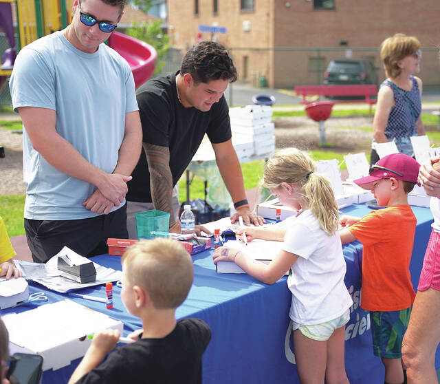 129893369_web1_Duryea-Food-Fun-2
RailRiders Zach Greene and Edgar Barclay help out at the crafts table to decorate STEM boxes.
Submitted photo