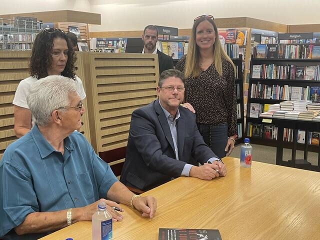 <p>William ‘Big Billy’ D’Elia and Matt Birkbeck, author, smile for a photo with Times Leader Media Group Publisher Kerry Miscavage at Friday evening’s book signing at Barnes & Noble in the Arena Hub Plaza.</p>
<p>Bill O’Boyle | Times Leader</p>