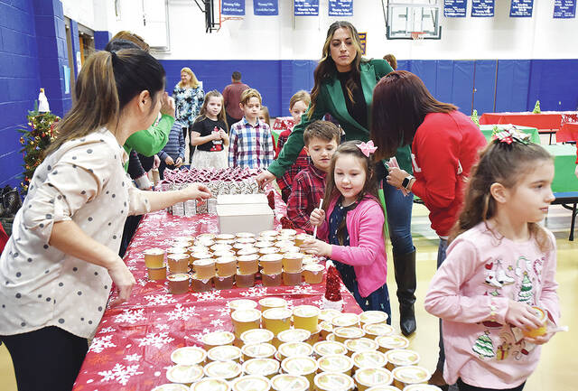 <p>Wyoming Area Catholic School students were treated to Breakfast with Santa on Tuesday, Dec. 5. Students are seen grabbing a drink of their choice.</p>