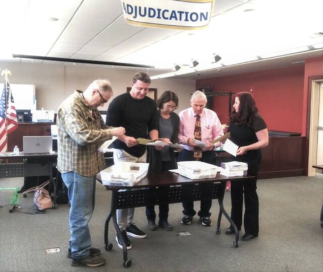 130613413_web1_electionboard--1-
Luzerne County’s volunteer election board inspects mail ballots on April 26, the first day of the April 23 primary election adjudication. From left, are: Daniel Schramm, Rick Morelli, Chairwoman Denise Williams, Albert Schlosser and Vice Chairwoman Alyssa Fusaro.