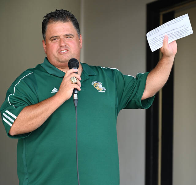 130773707_web1_Marranca-Dedication-1
Wyoming Area assistant football coach Mike Fanti holds a letter in his hand from Warrior head coach Randy Spencer who recently had an appendectormy and couldnt be at the Marranca dedication.
Tony Callaio | For Sunday Dispatch
