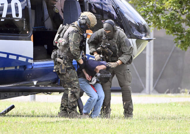130860116_web1_130860116-7a3ffe4baa06469d8e7f474f4fefbd60
The alleged perpetrator of the knife attack in Solingen is escorted from a helicopter in Karlsruhe, Germany, on Sunday. German police say a 26-year-old man has turned himself in, saying he was responsible for the deadly Solingen knife attack that left three dead and eight wounded at a festival marking the citys 650th anniversary.
dpa via AP