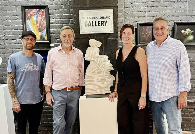 130929156_web1_Green-Kroptavich-Exhibit-1
Fellow sculpturer Scott Nichols, far left, joined City of Pittston Mayor Michael Lombardo, far right, as they gathered at Art e Fekts Gallery on Friday, Sept. 13 for the dual exhibit of sculpturer David Green, center left and photographer Mary Kroptavich, center right.
Submitted photo
