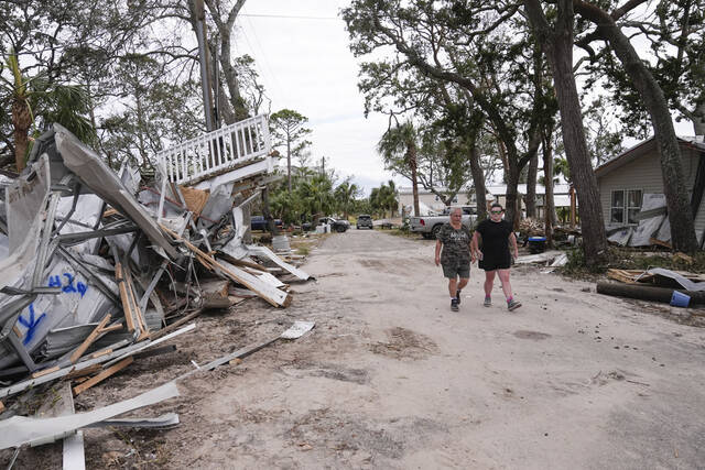 130946744_web1_AP24272600086905
Charlene Huggins, and her daughter-in-law, Katelyn Huggins, right, walk past the destruction on their street in the aftermath of Hurricane Helene, in Horseshoe Beach, Fla., on Saturday.
AP Photo