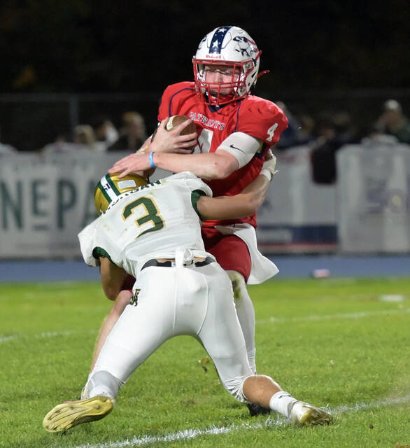 131018720_web1_WA-PA-ftbl-1
Pittston Area QB Matt Walter (4) gets stopped in the backfield by Warrior Jacob Morgan (3).
Tony Callaio | For Sunday Dispatch
