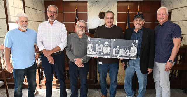 131035309_web1_Abilene-Photo-Presentation
Pittston-based country rock band Abilene members recently presented a 16x32 photo on canvas to the City of Pittston. The band will be inducted into the Luzerne County Arts & Entertainment Hall of Fame on Friday, Nov. 8 at the F.M. Kirby Center for the Performing Arts. From left: Mike Garzella, Lee Calabro, Jimmy Musto, City of Pittston Mayor Michael Lombardo accepting the photo on behalf of the city, Joe Wascavage, Joe Pacuska. Leo Mancini, fifth from the right in the photo, is deceased.
Tony Callaio | For Sunday Dispatch