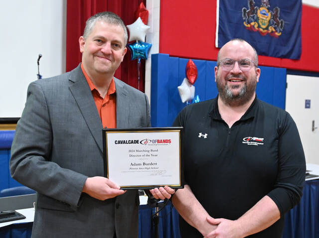 131383406_web1_PA-Adam-Burdett
Pittston Area Band Director Adam Burnett accepts his 2024 Cavalcade of Bands Director of the Year from Cavalcade of Bands President Adam Nobile during a Pittston Area School Board meeting on Tuesday.
Tony Callaio | For Sunday Dispatch