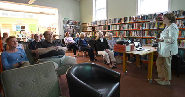 131486645_web1_WPHS-Artist-Program-1
Mary Portelli, right, West Pittston Historical Society president, presented a program at the West Pittston Library featuring West Pittston artists.
Tony Callaio | For Sunday Dispatch