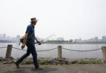 
			
				                                A man walks along the St. Lawrence River in front of the Old Port of Montreal on Friday. Smoke from the wildfires in the Canadian Prairies is causing poor air quality and reduced visibility in the Greater Montreal region.
                                 The Canadian Press via AP

			
		