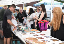 
			
				                                Behind the table, Logan Brace, right, and Joe Erzar, left, from Brace’s Orchard, will be busy on the first day of the City of Pittston’s Farmer’s Market, at the site of the Pittston Tomato Festival, on Tuesday, July 1.
                                 Tony Callaio file photo | For Sunday Dispatch

			
		