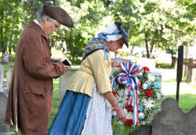 
			
				                                Sherry Emershaw, portraying Amy Harding, and Mark Kahn, portraying Rev. Joshua Entwhistle, as they play a wreath at the grave of Benjamin and Stukley Harding, who was killed by the Indians on June, 30, 1778.
                                 Tony Callaio | For Sunday Dispatch

			
		