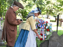 
			
				                                Sherry Emershaw, portraying Amy Harding, and Mark Kahn, portraying Rev. Joshua Entwhistle, as they play a wreath at the grave of Benjamin and Stukley Harding, who was killed by the Indians on June, 30, 1778.
                                 Tony Callaio | For Sunday Dispatch

			
		