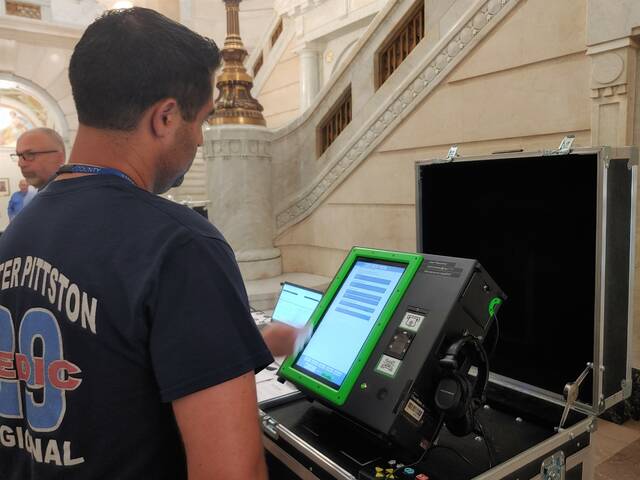 131636264_web1_voting1
Luzerne County Council Chairman John Lombardo checks out one of four voting system options during Wednesdays demonstration in the county courthouse in Wilkes-Barre. County officials are reviewing options for 2026 because the maintenance and support contract with the current supplier, Dominion Voting System, expires at the end of this year. Council will eventually decide whether to buy or lease a new system or negotiate an extended support contract with Dominion. In addition to Dominion, three other vendors demonstrated their systems Wednesday: Clear Ballot Group Inc., Election Systems and Software (ES&S) and Hart InterCivic. County Election Director Emily Cook said she is working on tallying price comparisons because figures from the bid report were not all based on the exact same equipment and terms.
Jennifer Learn-Andes | Times Leader