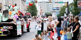 
			
				                                What would the parade be without children picking up tossed candy along the route, as shown here in 2024?
                                 Tony Callaio file photo | For Sunday Dispatch

			
		