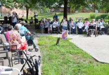 
			
				                                Wesley Village Chaplain Nathan King, standing at left, gives instructions on how each resident can release their butterfly on Thursday at Myers Manor.
                                 Tony Callaio | For Sunday Dispatch

			
		