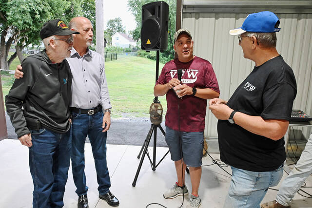 <p>Duryea VFW Quarter Master Dave Komar, right, is about to present special medals to Joe McFarland Sr, left, and his son, Joe McFarland, Jr., left center, with VFW Commander Danny Stella, right center, looking on.</p>
<p>Tony Callaio | For Sunday Dispatch</p>