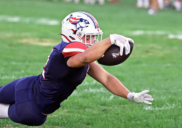 131734564_web1_PA-Mid-Valley-ftbl-1
Pittston Area junior running back Jude Ferentino lunges towards the goal line scoring the second Patriot touchdown for the night against Mid Valley Friday night.
Tony Callaio | For Sunday Dispatch