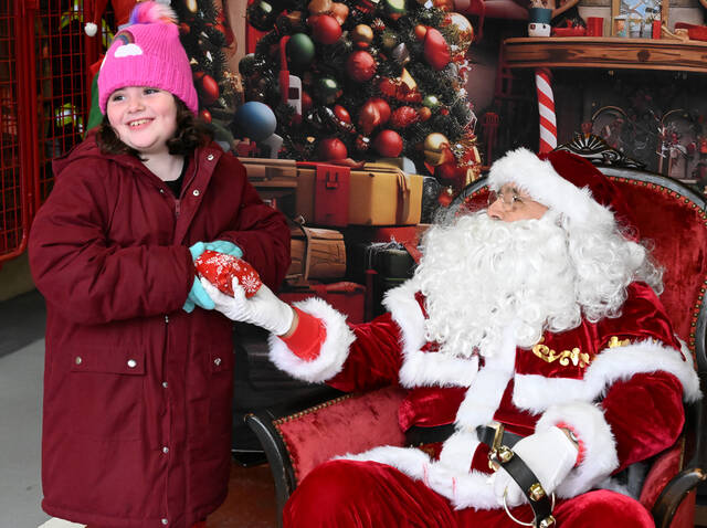 131764955_web1_Pittston-Shop-with-Cop-5
After sitting with Santa, Samantha Barry received a special gift from the Greater Pittston Santa Squad.
Tony Callaio | Sunday Dispatch File Photo