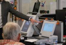 
			
				                                During a Tuesday demonstration, Luzerne County Election Board member Albert Schlosser, in foreground, watches Hart InterCivic representative Shawn Phillips point out an alert warning that too many candidate selections were made on a sample ballot fed into the company’s scanner.
                                 Jennifer Learn-Andes | Times Leader

			
		