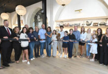 
			
				                                Natalie Ferretti (with scissors) stands next to her husband Tino and her children Grace and Santino, as she cuts the ribbon of the latest retail space in downtown Pittston, Natalie Grace Boutique, located at the Newrose Building, 48 S. Main St. 
                                 Tony Callaio | For Sunday Dispatch

			
		