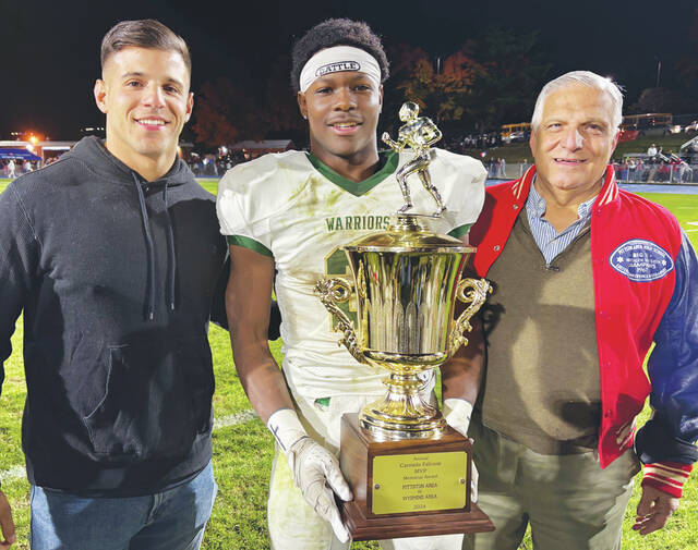 131859999_web1_WA-PA-ftbl-7
Wyoming Areas Lidge Kellum was the 2024 Carmelo Falcone Award MVP winner in the annual game against Pittston Area. From left: Sam Falcone (Carmelos great-grandson), Kellum and Carmen Falcone (Carmelos grandson).