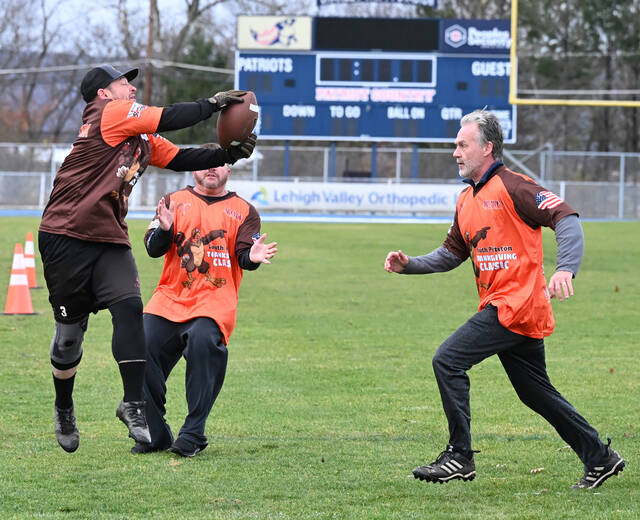 <p>Tony Ranieli, left, makes a tough catch with Robbie Williams, center, and game MVP Dave Girman, right, closing in to make the stop during the annual Greater Pittston Santa Squad Turkey Bowl game held at Trippi Stadium, Yatesville, last year.</p>
<p>Tony Callaio File Photo | For Sunday Dispatch</p>