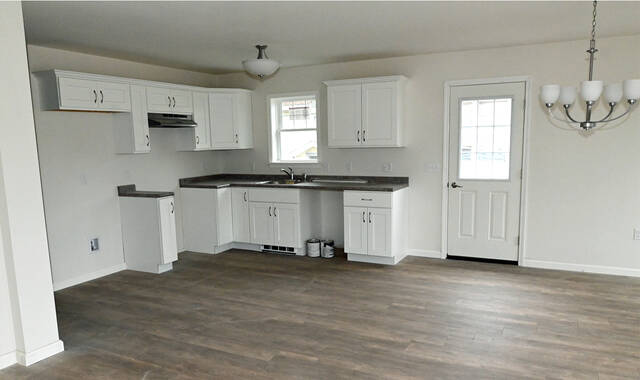 <p>The Northeast Pennsylvania Land Bank-owned house on Coolidge Street, Dupont, has an open-concept kitchen, living room, and dining room, along with three bedrooms and one bath.</p>
<p>Tony Callaio | For Sunday Dispatch</p>