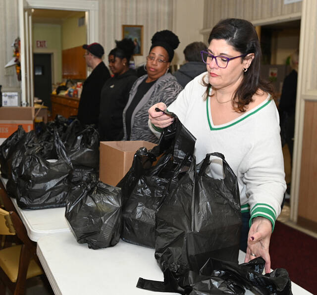 <p>Members of the First Baptist Church, Pittston, prepare turkey dinners to be packed and delivered.</p>
<p>Tony Callaio | For Sunday Dispatch</p>
