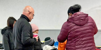 
			
				                                Pittston Knight Tom Ruschel, front left, aids a family that arrived for winter coats at the Knights of Columbus for the annual Coats for Kids drive on Saturday, Dec. 6.
                                 Submitted Photo

			
		