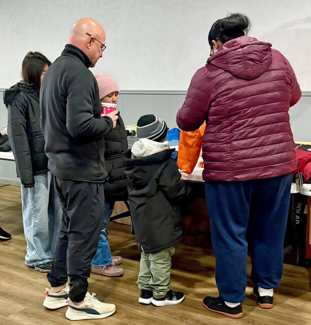131996151_web1_KoC-Coat-Drive-2
Pittston Knight Tom Ruschel, front left, aids a family that arrived for winter coats at the Knights of Columbus for the annual Coats for Kids drive on Saturday, Dec. 6.
Submitted Photo