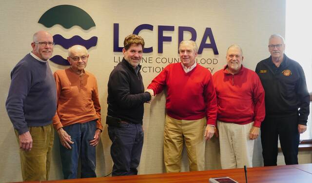 132004233_web1_fpa
Luzerne County Flood Protection Authority Executive Director Christopher Belleman, fourth from left, is congratulated following Tuesdays meeting the last before his Jan. 9 retirement. Authority Board members, from left, are: Vice Chairman William Hardwick, John Maday, Chairman Dominic Yannuzzi, Coray Mitchell and Jay Delaney.
Jennifer Learn-Andes | Times Leader