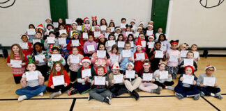 
			
				                                Third grade students from Wyoming Area Primary Center hold a $40 voucher in their hands to Burlington to put towards the purchase of a coat or shoes. Shown are the students from homerooms of Maryann Reino, Kelly Dragwa, and Katie Vanness.
                                 Tony Callaio | For Sunday Dispatch

			
		