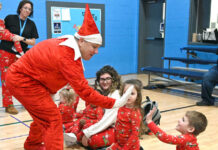 
			
				                                Santas number one Elf gives a Greater Pittston YMCA preschooler, two-year-old Harley Prawdzik, a high five during the annual Christmas toy giveaway.
                                 Tony Callaio | For Sunday Dispatch

			
		