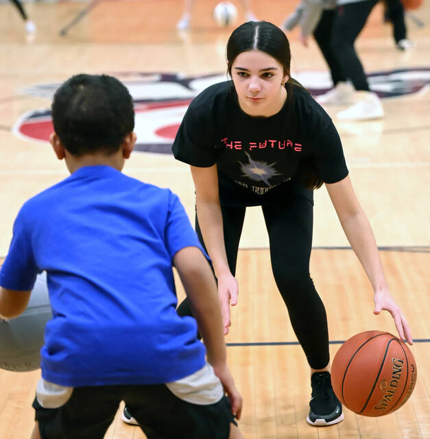 <p>Pittston Area up-and-coming player, Lexi Noone, aids one of the basketball campers at the Pittston Area gym.</p>
<p>Tony Callaio | For Sunday Dispatch</p>