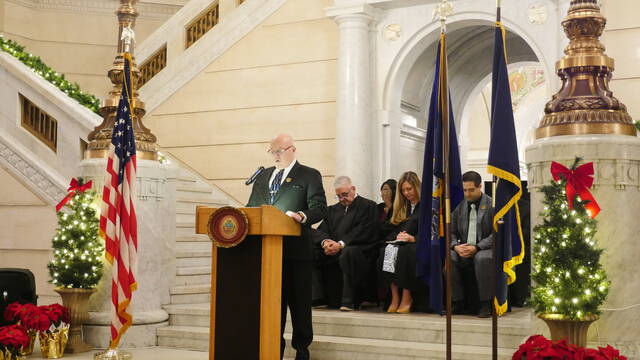 <p>Newly seated Luzerne County Councilman Steve Coslett gives the invocation during Monday evening’s swearing-in ceremony in the county courthouse rotunda.</p>
<p>Jennifer Learn-Andes | Times Leader</p>