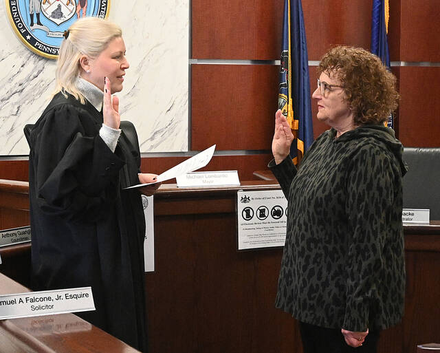 <p>Rosemary Frati, right, is sworn in as the City of Pittston treasurer by District Magistrate Alexandra Kokura Kravitz on Monday in city council chambers. Frati will be fulfilling the last two years of the late Chris Latona’s term.</p>
<p>Tony Callaio | For Sunday Dispatch</p>