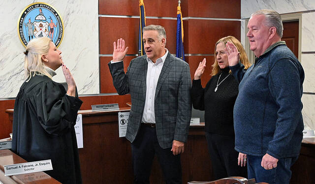 <p>District Magistrate Alexandra Kokura Kravitz, left, swears in City of Pittston incumbents, from left: Mayor Michael Lombardo and council members MaryPat Melvin Scarantino and Kenneth Bangs, on Monday in city council chambers.</p>
<p>Tony Callaio | For Sunday Dispatch</p>