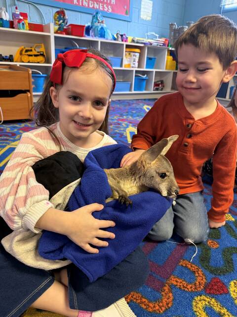 132082734_web1_Photo-3--2-
Grace Serafin and Ezra Chavez hold and pet the joey.
Submitted Photo