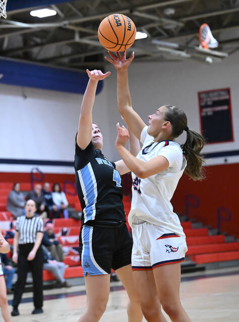 <p>Patriot Lili Hintze (21) gets over The Wolfpack’s Emily Barrouk (4) for a layup.</p>
<p>Tony Callaio | For Sunday Dispatch</p>