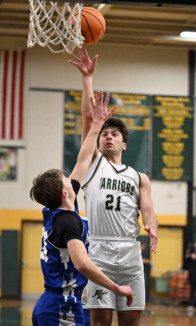 <p>The Warriors’ Bruno Pizzano (21) scores a field goal as he gets high over Hanover’s Ben Kolbicka (23).</p>
<p>Tony Callaio | For Sunday Dispatch</p>