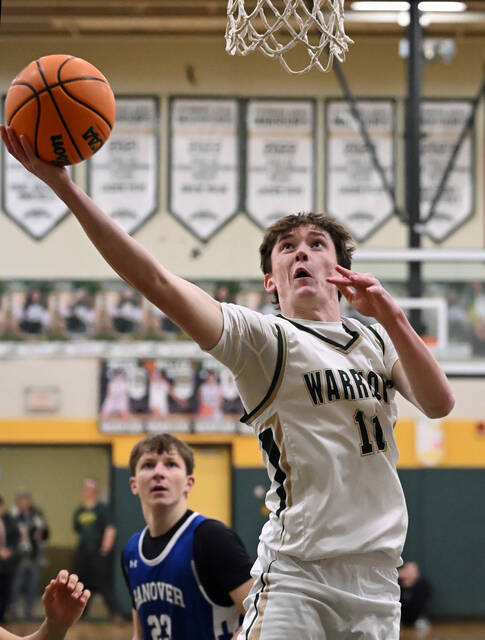 <p>The Warriors’ Drew Keating scores off a rebound against Hanover Area on Friday.</p>
<p>Tony Callaio | For Sunday Dispatch</p>