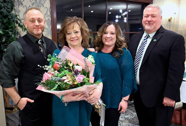 <p>The 2026 Women’s Network’s Distinguished Woman of the Year, Mary Rossi, stands with flowers in hand, with her twins, son, Nico, left, and daughter, Ashley, center right, along with her husband, Bill.</p>
<p>Tony Callaio | For Sunday Dispatch</p>