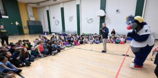 
			
				                                Adam Marco, SWB RailRiders communications director and boardcaster, along with team mascot, Champ, speak to second grade students of Wyoming Area Primary Center on the importance of reading on Thursday, March 12.
                                 Tony Callaio | For Sunday Dispatch

			
		