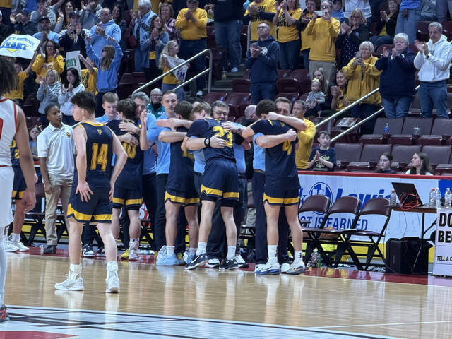 <p>Old Forge coaches and players hug after starters were removed from the lineup in Friday’s state final. Head coach J.J. Thomas is at right with Cameron Parker (4) while assistant Rick Notari is with Arthur Askew (23).</p>
<p>Tom Robinson | For Sunday Dispatch</p>