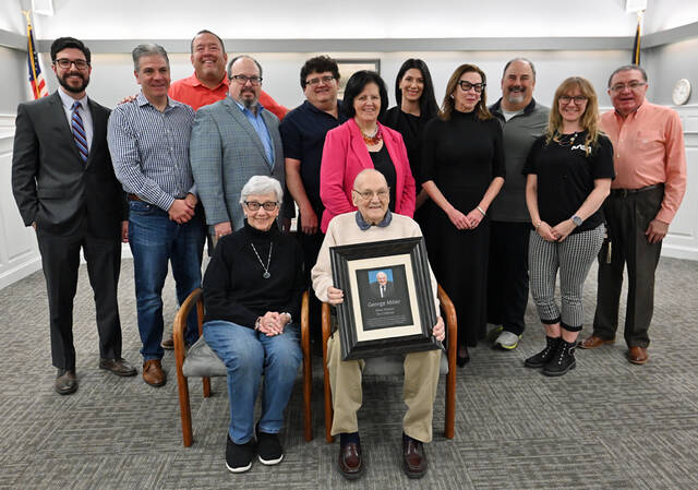 <p>George Miller and his wife Lois are seated in front of the West Pittston Council when they honored George on retiring after 26 years of service as the borough tax collector. Back row, left to right: Atty Joseph Burke, Jr., borough solicitor; John Kearns, Ian Stevenson, Jared Jordan, Michael Bugelholl, Toni Valenti, Arian Pupali, Ellen Quinn, Mayor Angelo Alfano, Kendra-lee O’Brien, borough secretary, Savino Bonita, borough manager.</p>
<p>Tony Callaio | For Sunday Dispatch</p>