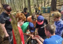 
			
				                                Wyoming Area students gather around Kings College professor Garrett Barr, at lower right, who is showing them an amphibian he found at the Lehman Sanctuary. The children found amphibians, too, and everyone released the little animals after gently examining them.
                                 Mary Therese Biebel | Sunday Dispatch

			
		