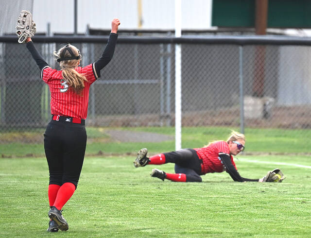 <p>Holy Redeemer right fielder Sadie Werner makes a diving catch to end the sixth inning with teammate Grace Stetz-Madden (3) cheering her on.</p>
<p>Tony Callaio | For Times Leader</p>