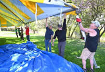 
			
				                                Mark Farrell, far right, one of the principal owners of Big Top Rentals, the major sponsor of the 55th Annual West Pittston Cherry Blossom Festival, along with co-workers, erects the second-largest tent for the festival this weekend, May 2 and May 3.
                                 Tony Callaio | For Sunday Dispatch

			
		